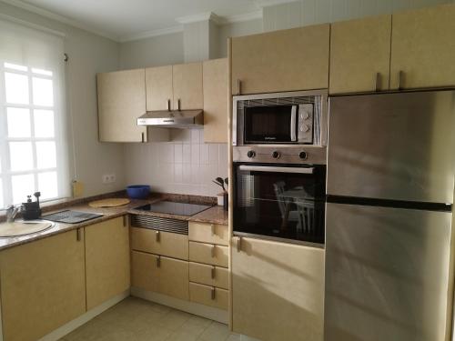 a kitchen with a refrigerator and a microwave at Traviesas in Vigo