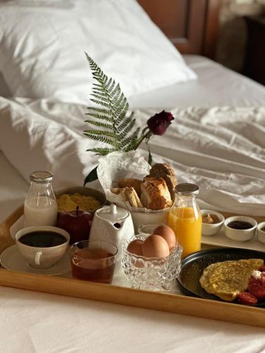 a tray of breakfast foods on a bed at Alseides Boutique Hotel & Spa in Elatochori