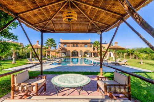 an image of a villa with a swimming pool at Villa Leila Farmhouse in Marrakech