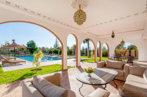 an estate with a swimming pool and a patio at Villa Leila Farmhouse in Marrakech