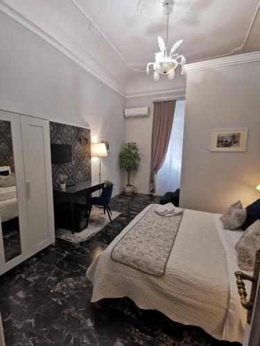 a bedroom with a bed and a chandelier at Il galleone in Messina