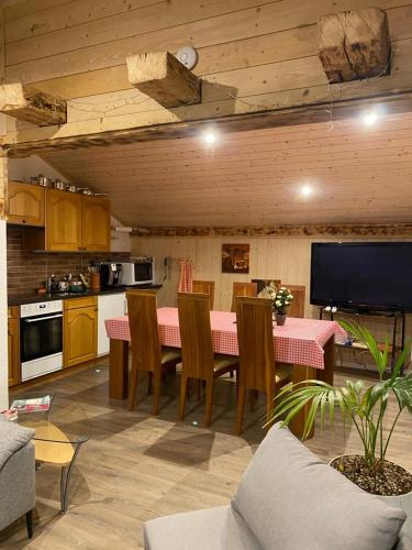 a kitchen with a pink table and chairs in a room at Chalet Bärgstäger in Lauterbrunnen