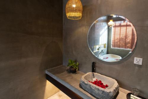 a bathroom with a sink and a mirror at Le Chanthou Boutique in Siem Reap