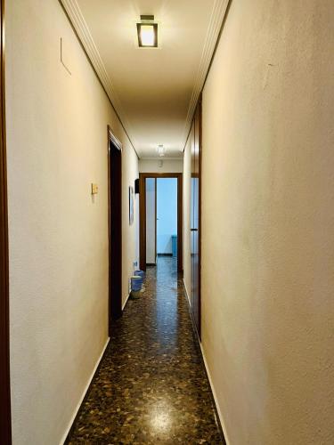 an empty hallway with a hallway leading to a bathroom at Apartamento Compartido con Vista al Puerto Valencia in Valencia