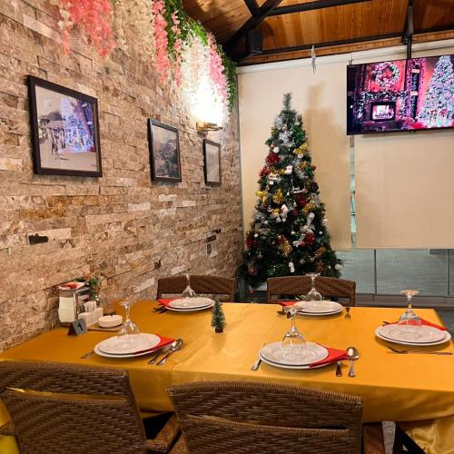 a table in a restaurant with a christmas tree at Sheki Hilal Boutigue in Sheki