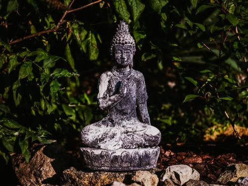 a statue sitting on top of some rocks at Penzion U TŘÍ RŮŽÍ - Adults Only in Vrbice