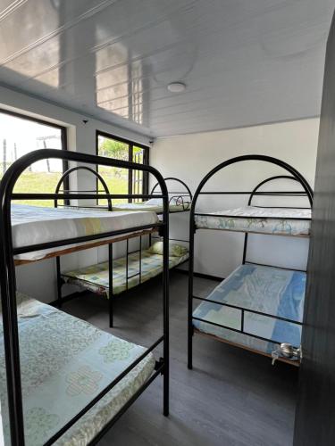 a room with three bunk beds and a window at casa campestre in Fusagasuga