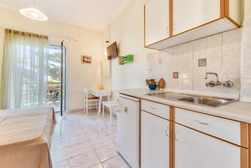 a kitchen with a sink and a counter top at Panorama Studios & Apartments in Amoudi