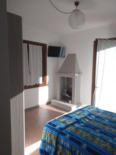 a bedroom with a bed and a fireplace at Casa Artemis (Artemis House) in Cerreggio