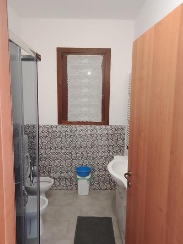 a bathroom with a toilet and a sink at Casa Artemis (Artemis House) in Cerreggio