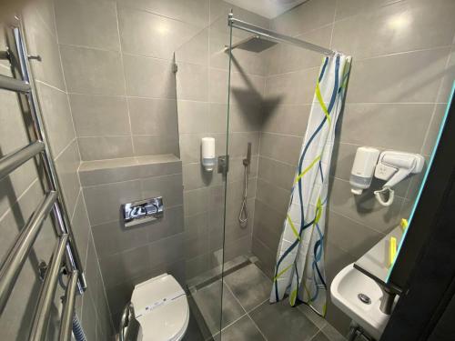 uma pequena casa de banho com chuveiro e WC em HOTEL ARTA em Starychi