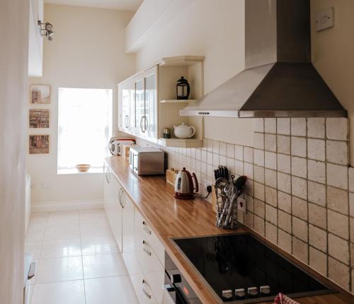 a kitchen with a sink and a stove at Manor Court in Penzance