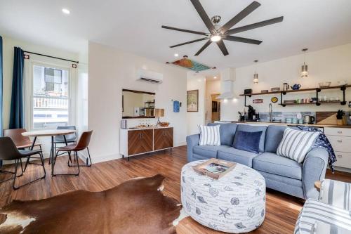 a living room with a blue couch and a kitchen at Judy's Nest at the Wessels-Boyd House. in Savannah