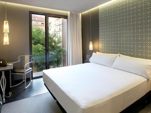 
A bed or beds in a room at TWO Hotel Barcelona by Axel 4* Sup- Adults Only
