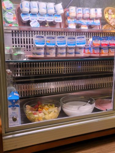 a refrigerator filled with lots of different types of food at KYRIAD ORANGE Centre Ville - HOTEL & RESTAURANT & BAR - La Galerie d'Art des Princes - Provence Alpes Côte d'Azur - France - Proche A7-A9 - exit21- Châteauneuf-du-Pape Avignon Bollene Nimes - 24h-24h in Orange