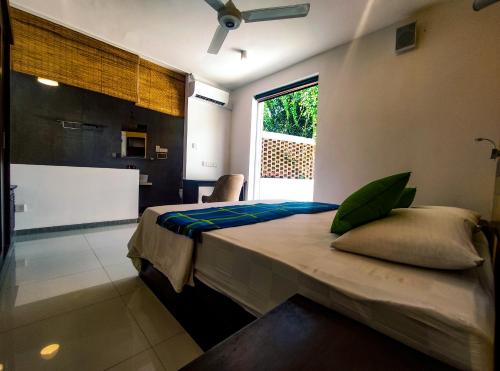 a bedroom with a bed and a large window at The Yacht Riverside Villa Near Colombo International Airport in Ganepola