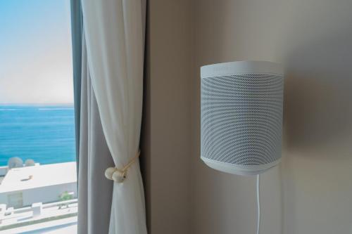 a speaker on a wall next to a window at Private 250sqm Garden Duplex, Jacuzzi, Cinema, Sea View Escape in Torremolinos