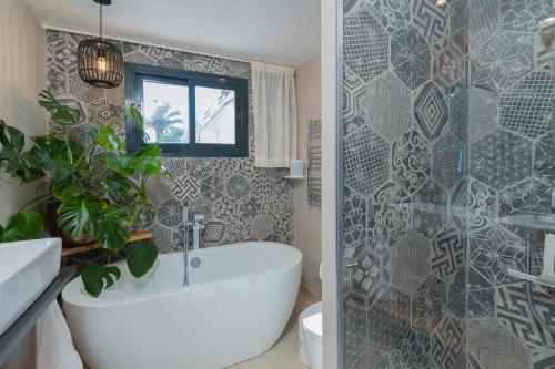 a bathroom with a tub and a shower and a toilet at Private 250sqm Garden Duplex, Jacuzzi, Cinema, Sea View Escape in Torremolinos