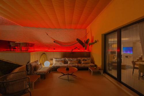 a living room with a couch and a table at Private 250sqm Garden Duplex, Jacuzzi, Cinema, Sea View Escape in Torremolinos
