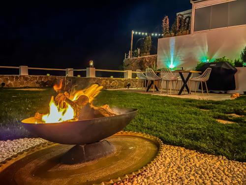 a fire pit in the middle of a yard at night at Private 250sqm Garden Duplex, Jacuzzi, Cinema, Sea View Escape in Torremolinos
