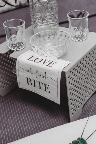 a table with glasses and a sign that reads loved at first bite at Villa La'Vie in Witbank