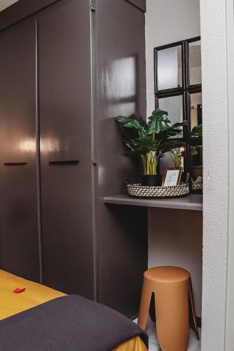 a room with a bed and a table and a stool at Villa La'Vie in Witbank