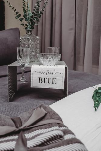 a table with a sign that says all first bite at Villa La'Vie in Witbank