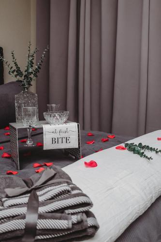 a table with a white blanket and a sign that says all candy bite at Villa La'Vie in Witbank