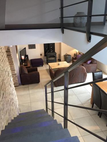 a staircase leading to a living room and a living room at Gîte de Kermal in Bannalec