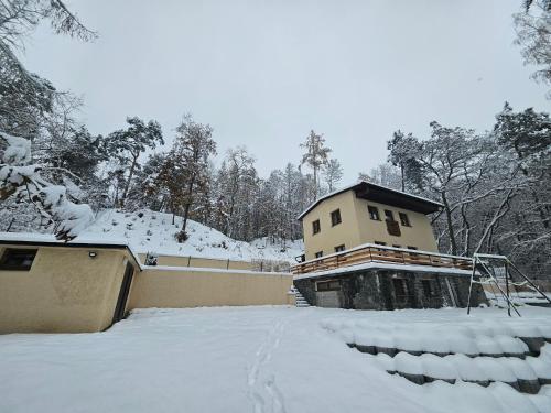 a house with snow on the ground in front of it at Bohemian Paradise near Prague with Wellness in Řehenice