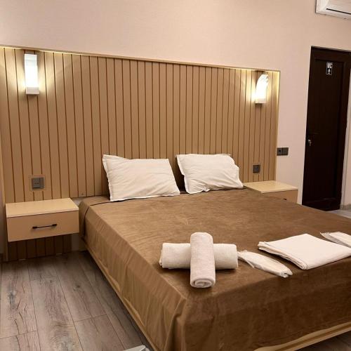 a bedroom with a bed with two towels on it at Sheki Hilal Boutigue in Sheki