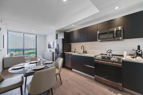 a kitchen with a table and chairs in a kitchen at Captivating Bayside Apartment at Downtown Miami in Miami