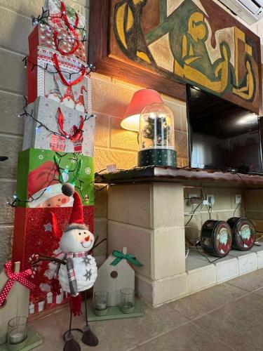 a christmas kitchen with a snowman and a stove at House of Roses in Limassol