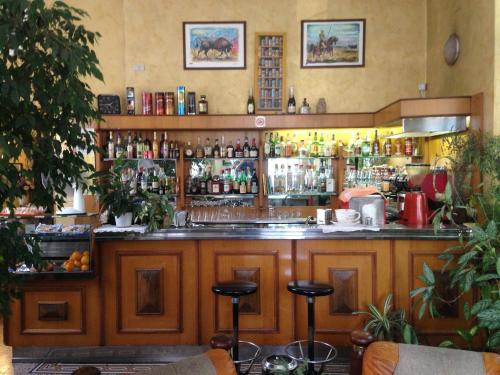 a bar in a restaurant with a lot of bottles at Hotel Rey in Turin