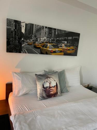 a picture of a woman with sunglasses on a bed at Welcome to Bucharest Airport Residences & Therme-SELF CHECK-IN in Otopeni