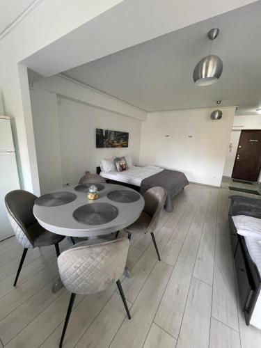 a room with a bed and a table and chairs at Welcome to Bucharest Airport Residences & Therme-SELF CHECK-IN in Otopeni