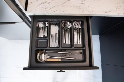 a black box filled with utensils sitting on a counter at PARIS Opulent Lifestyle in Drama