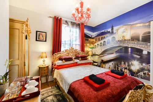 a bedroom with a large bed with a painting of a bridge at Mama’s Inn Boutique Guest House in Nottingham