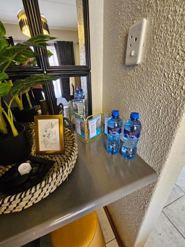 a table with two bottles of water on it at Villa La'Vie in Witbank
