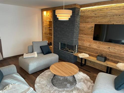 a living room with a couch and a fireplace at Appartement Everest in Zermatt