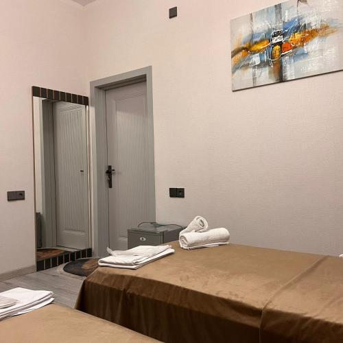 Zimmer mit einem Bett und einem Gemälde an der Wand in der Unterkunft Sheki Hilal Boutigue in Şəki