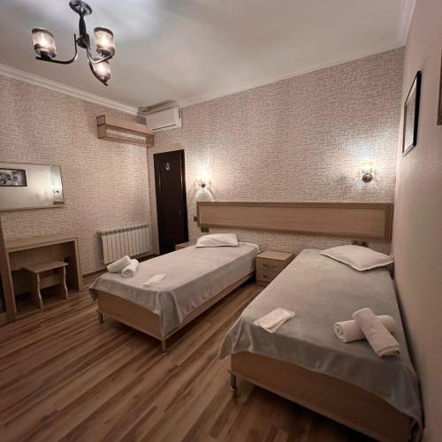 a room with two beds and a fireplace at Sheki Hilal Boutigue in Sheki