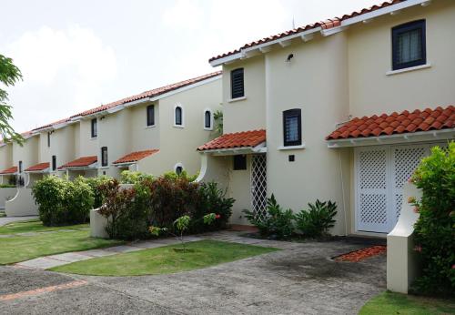 a row of white buildings with red roofs at Admiral's Quay #5 - Comfortable 1-bed Townhouse townhouse in Rodney Bay Village