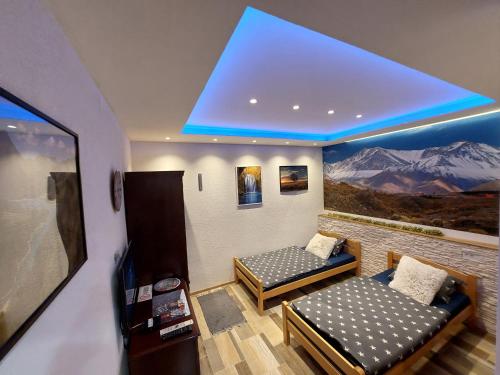 a room with two beds and a large window at SKS plus in Pale