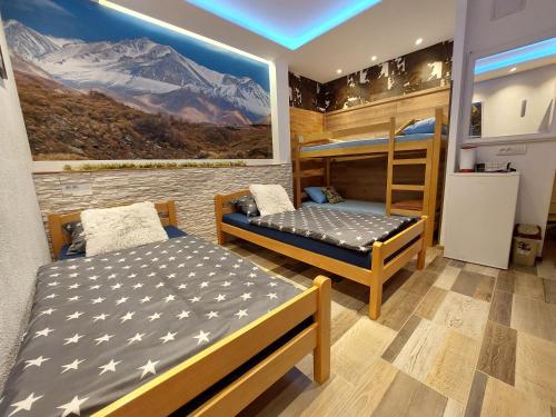 a room with two beds and a bunk bed at SKS plus in Pale