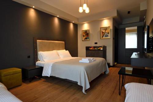 a bedroom with a large bed with white sheets at Living Rooms Hotel in Skopje