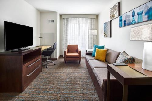 a living room with a couch and a desk at Residence Inn by Marriott Lynchburg in Lynchburg