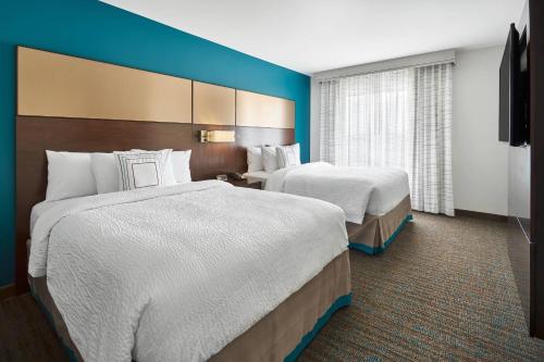 two beds in a hotel room with blue walls at Residence Inn by Marriott Lynchburg in Lynchburg