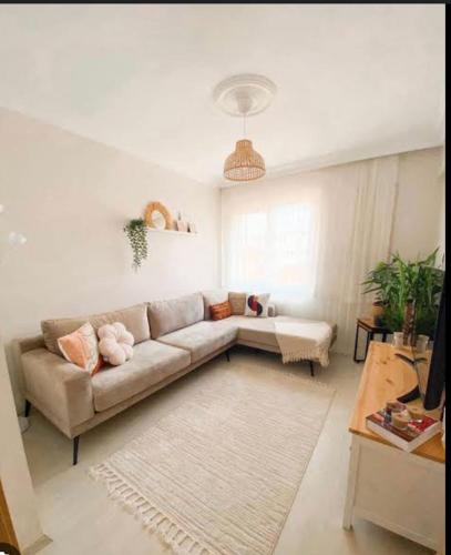 a living room with a couch and a table at diana apartman in Şekerpınarı