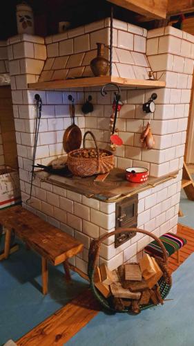 a brick oven with a bench and utensils at Na wsi Zalesie 53 in Wyszki